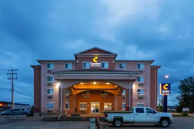 a building with a truck parked in front of it at Comfort Inn & Suites in Edson