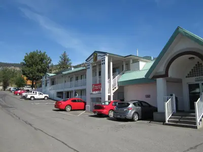 a group of cars parked in front of a hotel at Sage Inn Merritt BC in Merritt