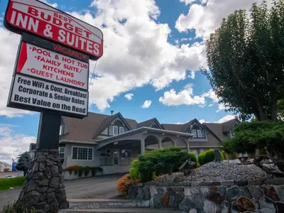a sign in front of a house at Best Budget Inn & Suites Kamloops in Kamloops