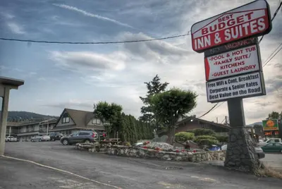 a sign for a inn and suites on a street at Best Budget Inn & Suites Kamloops in Kamloops