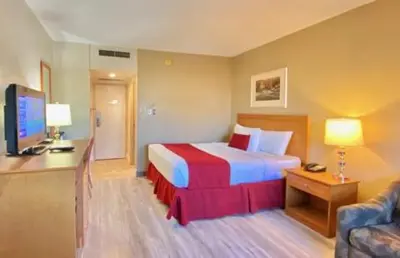 a hotel room with a bed and a television at Travelodge by Wyndham Edmonton East in Edmonton