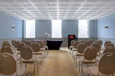a room with rows of chairs and a podium in it at Ramada Plaza by Wyndham Calgary Downtown in Calgary