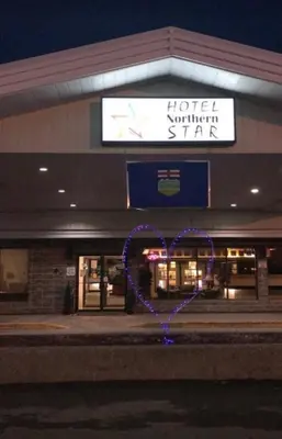 a heart is lit up in front of a store at Northern Star Hotel & Convention Center in Slave Lake