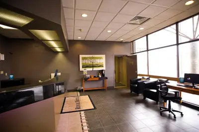 an office with desks and chairs in a room with windows at Royal Hotel Lloydminster in Lloydminster