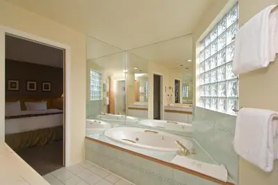 a bathroom with three sinks and a large mirror at Snowbird by Bill in Whistler