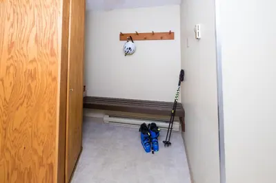 a hallway with a room with a door with a vacuum at Snowbird by Bill in Whistler
