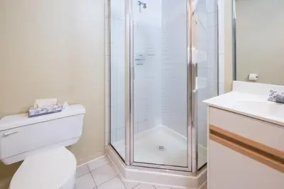 a bathroom with a shower and a toilet and a sink at Snowbird by Bill in Whistler