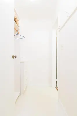 a white room with a white floor and a door at English Bay Hotel in Vancouver