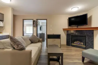 a living room with a couch and a fireplace at Best Western Premier Aberdeen Kamloops in Kamloops