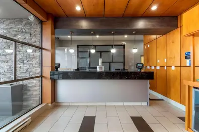 a large lobby with a counter in a building at Best Western Premier Aberdeen Kamloops in Kamloops