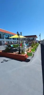 a row of tables and chairs and a patio at Riverside Motel in Penticton