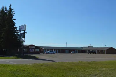 an empty parking lot in front of a motel at A1 Motel And Campground in Bassano