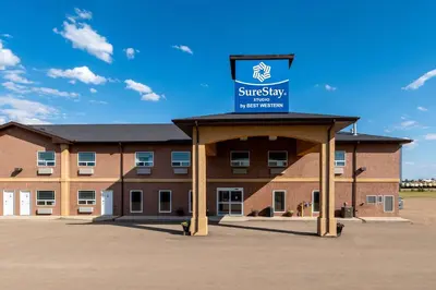 a building with a sign on top of it at SureStay Studio by Best Western Hardisty in Hardisty