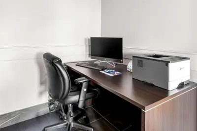 an office with a desk with a computer and a printer at SureStay Studio by Best Western Hardisty in Hardisty