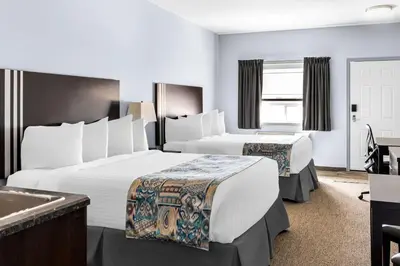 a hotel room with two beds and a sink at SureStay Studio by Best Western Hardisty in Hardisty