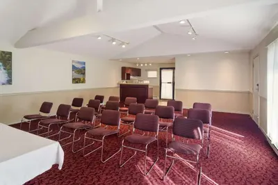 a room with chairs and a table and a podium at SureStay by Best Western North Vancouver Capilano in North Vancouver