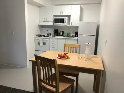 a kitchen with a wooden table with a plate of fruit on it at UBC Okanagan Campus in Kelowna
