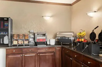 a kitchen with a counter top with fruits and vegetables at Quality Inn & Suites in Vernon