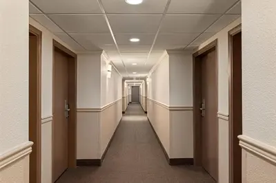 a hallway in a building with a long corridor at Quality Inn & Suites in Vernon