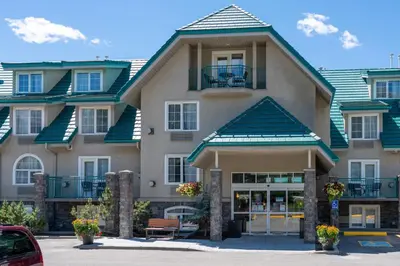 a large apartment building with a balcony at Pocaterra Inn & Waterslide in Canmore