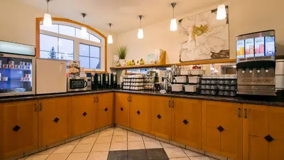 a coffee shop with a counter in a store at Pocaterra Inn & Waterslide in Canmore