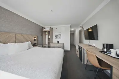 a hotel room with a large bed and a desk at Sandman Hotel Red Deer in Red Deer
