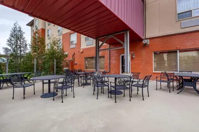 a group of tables and chairs in front of a building at Best Western Plus Meridian in Lloydminster