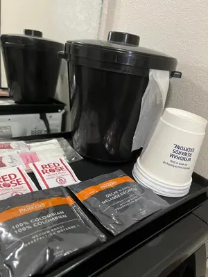 a slow cooker and a coffee pot on a counter at Super 8 by Wyndham Whitecourt in Whitecourt