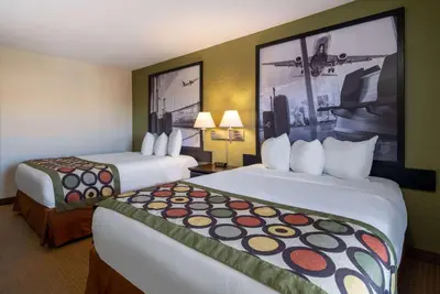 a hotel room with two beds and two lamps at Super 8 by Wyndham Edmonton International Airport in Leduc