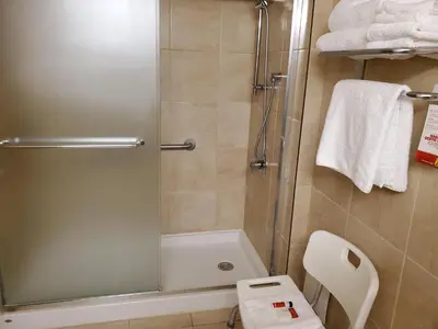 a bathroom with a shower and a toilet at Super 8 by Wyndham Edmonton International Airport in Leduc
