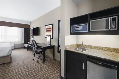 a hotel room with a bed and a desk at Best Western Premier Freeport Inn Calgary Airport in Calgary