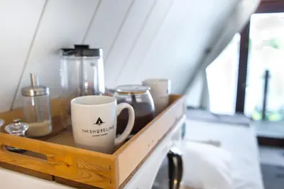 a wooden shelf with a coffee cup on it at The Shoreline Tofino in Tofino