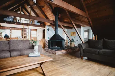 a living room with a couch and a fireplace at The Shoreline Tofino in Tofino