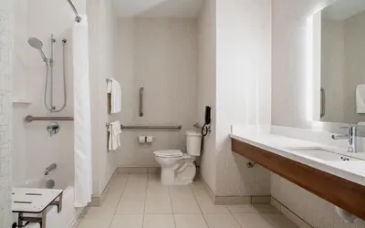 a white bathroom with a toilet and a sink at Holiday Inn Express & Suites Kelowna - East by IHG in Kelowna