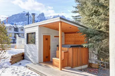 a small white shed with a wooden roof at Lady MacDonald Country Inn in Canmore