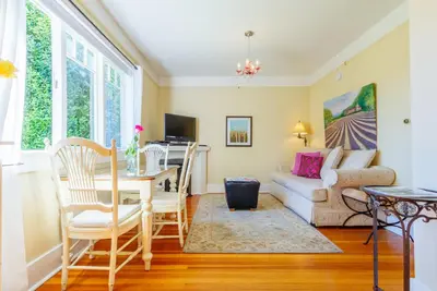 a living room with a couch and a table at Fairholme Manor Inn in Victoria
