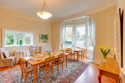 a dining room with a table and chairs at Fairholme Manor Inn in Victoria