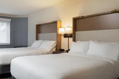 a hotel room with two beds and two lamps at Holiday Inn Victoria - Elk Lake by IHG in Victoria