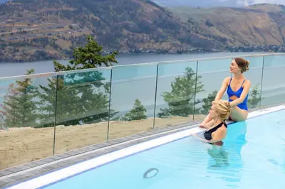 a woman in the water in a swimming pool at Sparkling Hill Resort and Spa - Adults-Only Resort in Vernon
