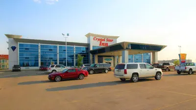 a car dealership with cars parked in a parking lot at Crystal Star Inn Edmonton Airport with free shuttle to and from Airport in Leduc