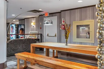 a dining room with a table and a bench at The Bedford Regency Hotel in Victoria