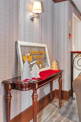 a table with a framed picture on top of it at The Bedford Regency Hotel in Victoria