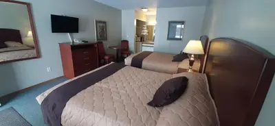 a hotel room with two beds and a mirror at Mary's Motel in Golden