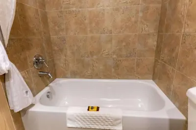 a white bath tub in a bathroom at Best Western Plus South Edmonton Inn & Suites in Edmonton