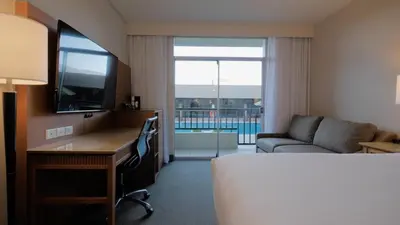 a hotel room with a bed and a desk and a couch at Coast Capri Hotel in Kelowna