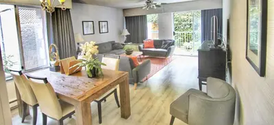 a living room with a wooden table and chairs at Best Western Plus Regency Inn and Conference Centre in Abbotsford