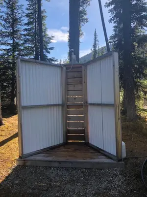 a out house with two gates and a ladder at Vines and Puppies Hideaway in Jade City