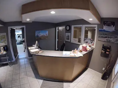 a restaurant with a counter in the middle of a room at Avalon Inn in Osoyoos