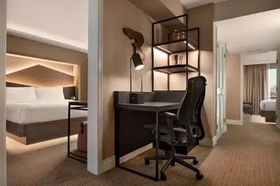 a hotel room with a desk and a bed at Hilton Vancouver Airport in Richmond