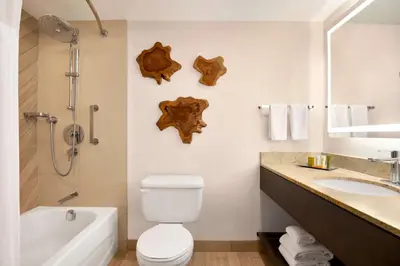 a bathroom with a white toilet and a sink at Hilton Vancouver Airport in Richmond